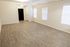 Spacious, bright room with hardwood floors and large windows, offering a versatile layout for comfortable living.