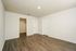 Bright and spacious bedroom with elegant laminate flooring and walk-in closet, offering a modern and inviting atmosphere.