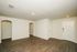 Spacious, modern living area with elegant wood flooring and fresh white walls, ideal for stylish urban living.