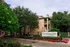 Charming Greenbriar Park apartment complex surrounded by lush greenery and vibrant flowers.