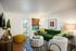 Inviting living room with a stylish green sofa, modern decor accents, and natural light streaming through glass doors.