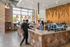 Vibrant cafe interior with stylish hexagonal tile counter, large windows, and modern design elements, creating a welcoming atmosphere for patrons.