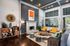 Modern, sunlit living room featuring stylish seating, vibrant decor, and a cozy fireplace, perfect for relaxation and entertaining.