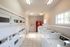 Bright and efficient apartment laundry room equipped with modern washers, dryers, and vending machine.