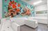 Bright and welcoming pet washing station featuring colorful mural of playful dogs and paw prints, with modern tiled basins and natural light.