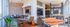 Chic communal space featuring a modern lounge area, stylish exposed brick walls, a ping pong table, and a sleek foosball setup, perfect for socializing and relaxation.