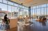 Modern open-plan office space with floor-to-ceiling windows, natural light, and stunning city views.