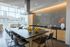 Modern kitchen with chic island seating, elegant tile backsplash, and expansive windows showcasing city views.