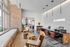 Modern reception area at St. Andrie with chic seating, exposed brick wall, and warm lighting, creating an inviting atmosphere.
