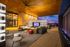 Luxurious covered patio with stylish seating, ambient lighting, and panoramic sunset views, perfect for relaxation and entertainment.