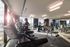 Modern fitness center with state-of-the-art cardio equipment, sunlit space, and sleek design.