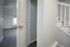 Inviting interior with an open door showing a room with hardwood flooring and a staircase.