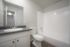 Bright and stylish bathroom featuring a modern sink, toilet, and bathtub with sleek fixtures.