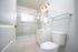 Modern, bright bathroom featuring sleek glass shower, elegant fixtures, and a crisp white palette.