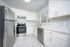 Bright, modern kitchen featuring sleek stainless steel appliances, elegant white cabinetry, and a stylish marble backsplash.