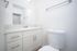 Modern bathroom with sleek white cabinetry, stylish sink, and elegant fixtures for a contemporary design.