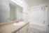 Bright and modern bathroom featuring sleek fixtures, a spacious countertop with built-in sink, and elegant tile flooring.