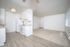 Bright and inviting apartment kitchen with modern appliances, sleek countertops, and seamless open layout flowing into a cozy living space.
