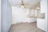 Bright, modern kitchen with elegant white cabinetry, sleek countertops, and a contemporary ceiling fan accentuating the spacious layout.