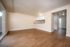 Bright and inviting living space with wood-look flooring, open layout, and sliding glass door for ample natural light.