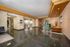 Elegant apartment lobby with modern decor, featuring polished floors, stylish seating area, and dual elevators.