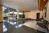 Elegant building lobby with glossy floors, modern seating, and a serene indoor garden feature.