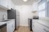 Sleek modern kitchen with stainless steel appliances, elegant white cabinetry, and stylish countertops, offering a bright and functional cooking space.