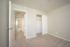Bright and inviting bedroom with plush carpet, ample closet space, and a modern neutral palette.