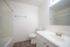 Elegant bathroom with modern fixtures, sleek white countertops, and a spacious bathtub in a bright, airy setting.