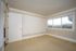 Bright and airy room with large window offering stunning views, featuring neutral wall colors and elegant trim.