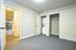Bright and spacious room with elegant closet and in-unit laundry, showcasing modern interior design and easy access to the adjacent hallway.