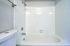 Inviting modern bathroom with a pristine white tiled shower and tub, perfect for relaxation.