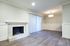 Elegant living room with a modern fireplace and large sliding glass doors, offering abundant natural light and a welcoming atmosphere.