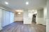 Modern open-concept layout with elegant wood flooring, bright living area, and sleek kitchen featuring stainless steel appliances.