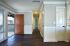Bright and welcoming apartment entrance with elegant wood flooring, natural light from large windows, and sleek modern design.