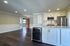 Modern open-concept kitchen with sleek cabinetry, stainless steel appliances, and expansive living area, perfect for contemporary living.