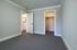 Inviting bedroom featuring plush carpet, a walk-in closet, and an ensuite bathroom, offering comfort and convenience.