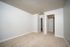 Bright and inviting room with soft beige carpet, freshly painted walls, and white trim, perfect for a cozy living space.