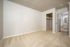 Inviting bedroom with plush carpeting and a spacious walk-in closet, leading to a well-lit bathroom.