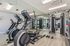 Modern fitness center featuring sleek cardio machines, weight training equipment, and mirrored walls for an invigorating workout experience.