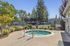 Charming outdoor area with a sparkling jacuzzi surrounded by lush greenery, perfect for relaxation and rejuvenation.