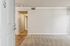 Inviting apartment entryway with fresh carpet and appealing natural light, leading to a cozy hallway.