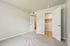 Bright and inviting bedroom with plush carpet and spacious walk-in closet, offering ample storage space.