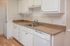 Modern kitchen with sleek countertops, white cabinets, and integrated appliances, offering a functional and stylish cooking space.