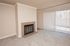 Bright and inviting living room with a cozy fireplace and large sliding glass doors opening to a private patio.