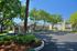 Charming apartment complex nestled among lush greenery with stylish architecture and spacious balconies.