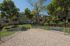 Charming apartment complex with lush landscaping and a pet-friendly outdoor space, perfect for enjoying sunny days.