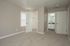 Bright and inviting bedroom featuring soft carpet, fresh neutral walls, and an en-suite bathroom with modern fixtures.