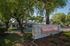 Welcoming entrance to Sandpiper Village, showcasing lush greenery and a stone sign exuding charm and tranquility.