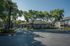 Charming apartment complex surrounded by lush trees and vibrant greenery, featuring modern architecture and serene pathways.